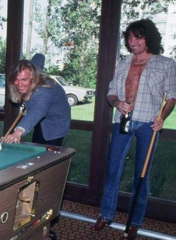 Robin Zander enjoying some pool with his fellow frontman Bon Scott.